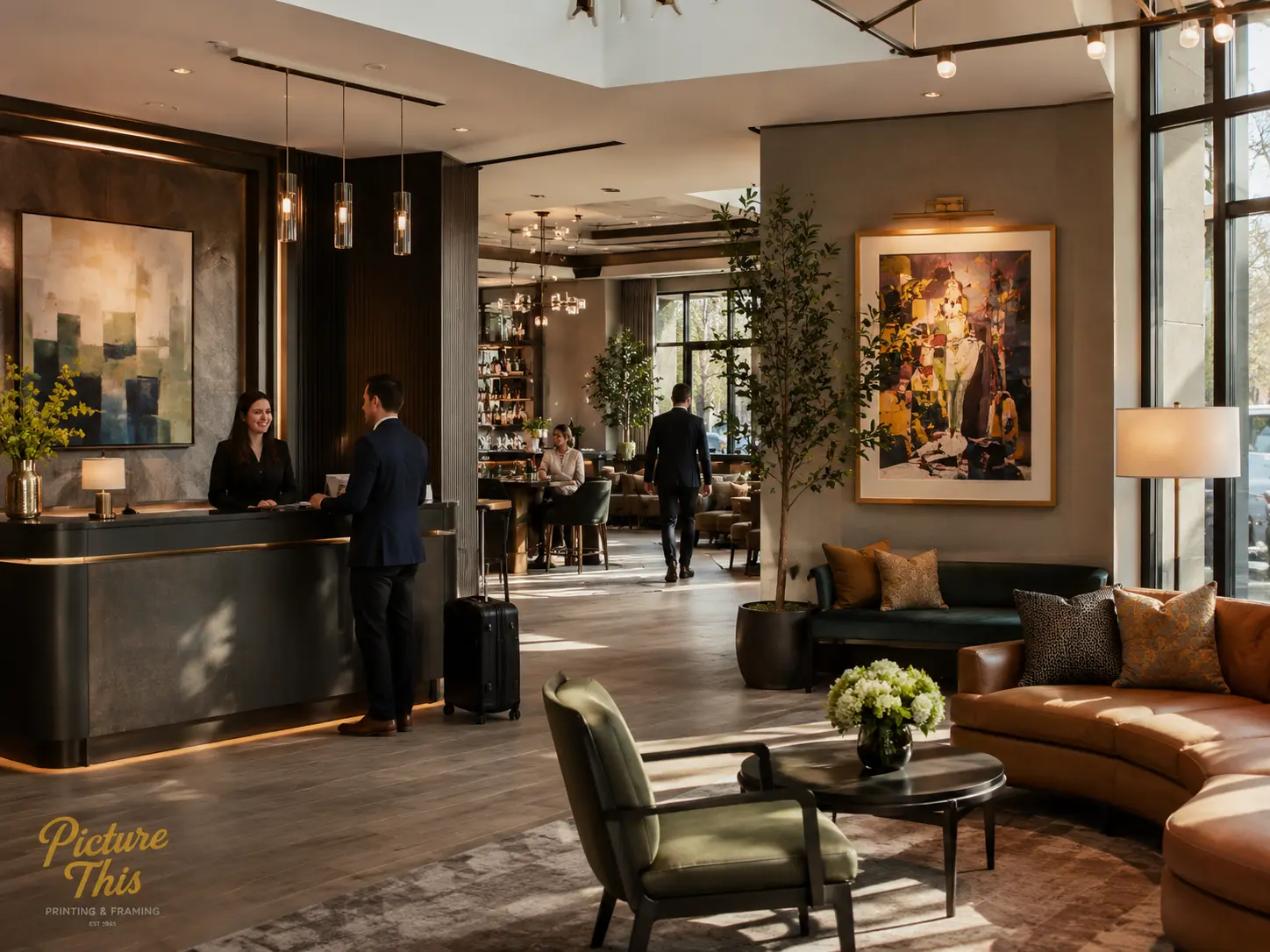 Luxury hotel lobby with custom framed artwork at reception and lounge areas